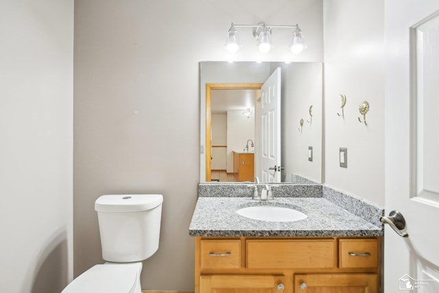 bathroom featuring toilet and vanity