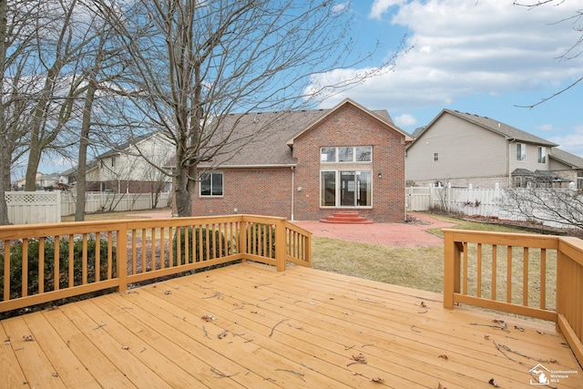 deck featuring fence private yard, a yard, and entry steps