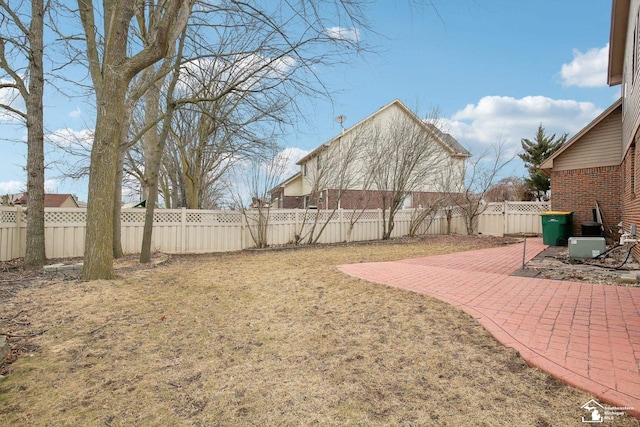 view of yard with a patio area and a fenced backyard