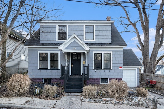 view of front facade with a garage, fence, a chimney, and a shingled roof