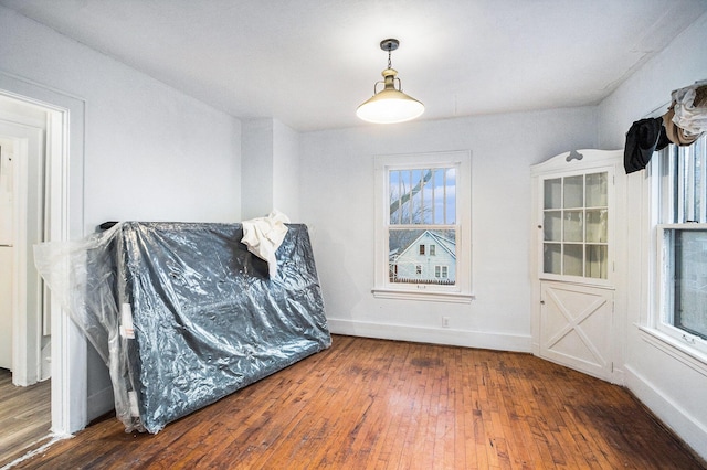 sitting room with baseboards and hardwood / wood-style floors