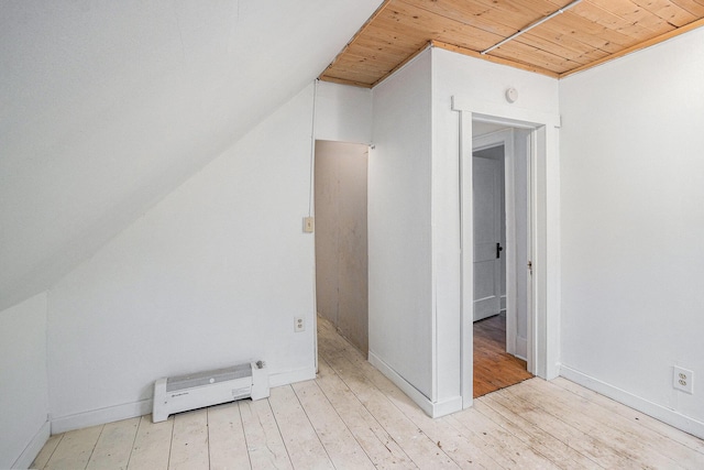 bonus room featuring baseboards, baseboard heating, wooden ceiling, and light wood-style floors