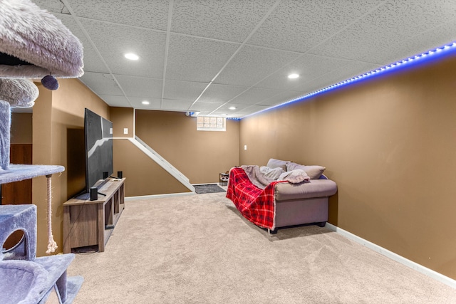 interior space featuring baseboards, a drop ceiling, and recessed lighting