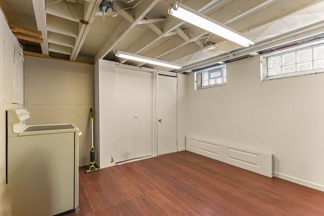 basement featuring wood finished floors and washer / dryer