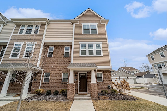 townhome / multi-family property featuring brick siding