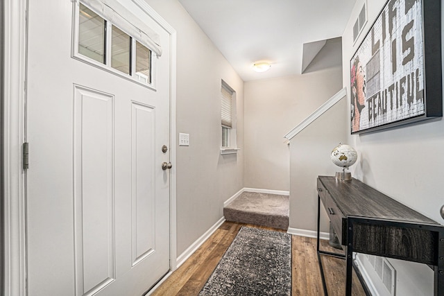 entrance foyer featuring visible vents, baseboards, and wood finished floors