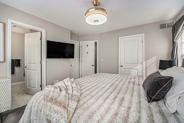 bedroom with visible vents and baseboards