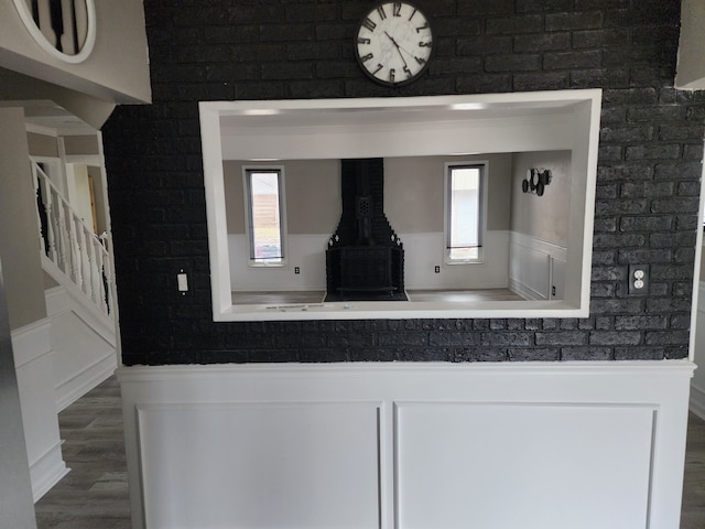 details with a wainscoted wall and wood finished floors