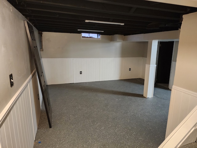 basement with a wainscoted wall