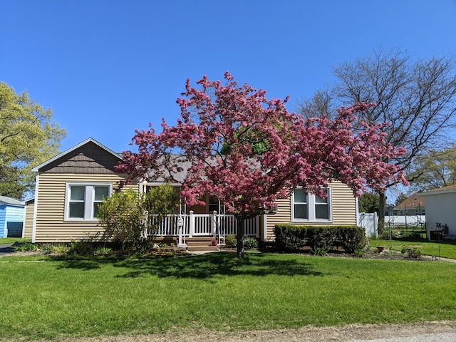 obstructed view of property featuring fence and a front yard