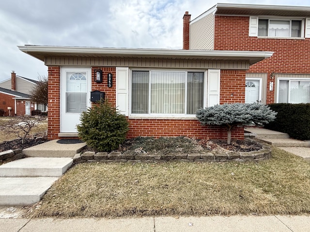 view of front of home featuring brick siding