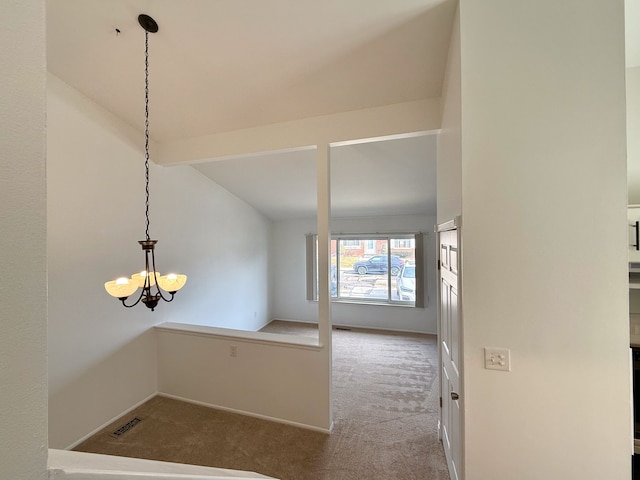 interior space with visible vents, baseboards, vaulted ceiling, carpet, and an inviting chandelier