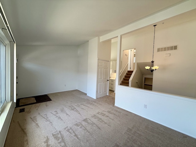 unfurnished room with stairs, carpet, visible vents, and a notable chandelier