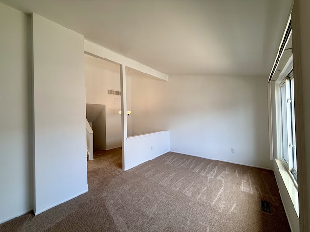 empty room featuring carpet flooring and visible vents