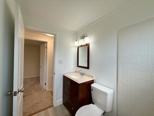 bathroom featuring vanity, toilet, and baseboards