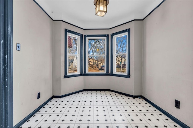 empty room featuring light floors and baseboards