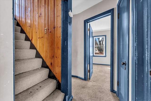 stairway featuring carpet flooring and baseboards