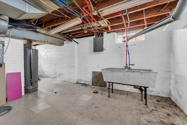 basement with water heater, a sink, electric panel, and tile patterned floors