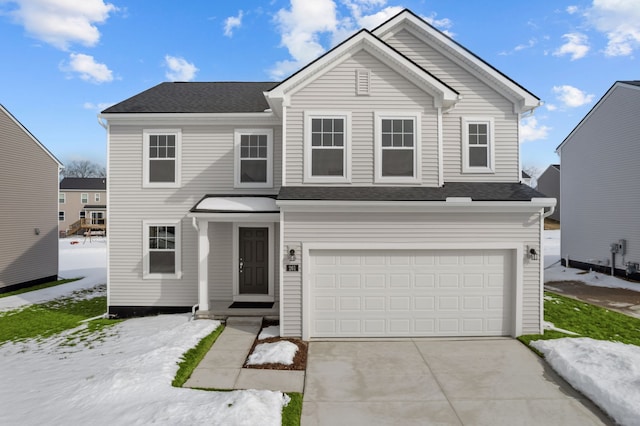 traditional-style home with driveway, an attached garage, and a shingled roof