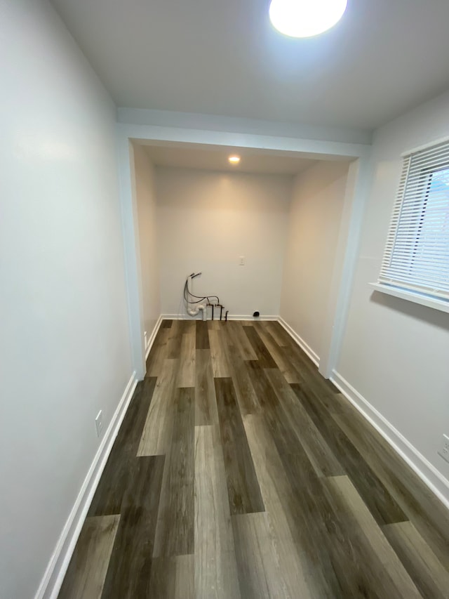 laundry room featuring baseboards and dark wood-style flooring