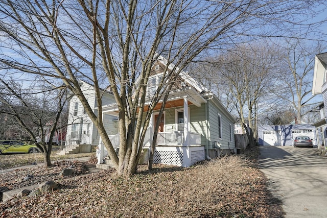 view of front of house with crawl space, covered porch, and an outdoor structure