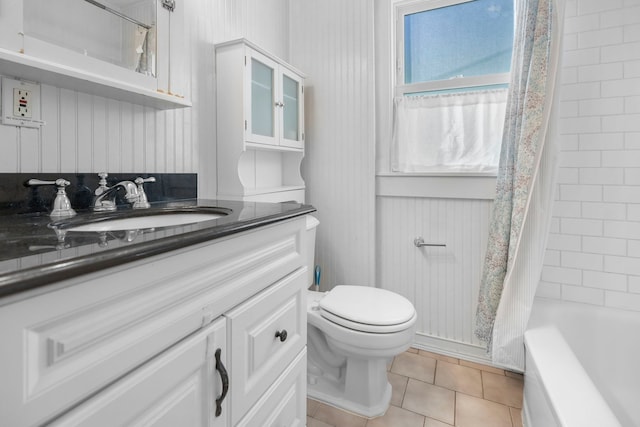 full bathroom featuring tile patterned flooring, shower / tub combo, toilet, and vanity