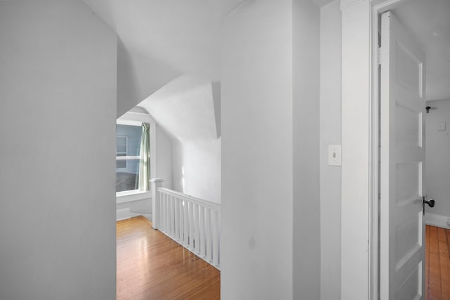 hall featuring hardwood / wood-style floors and an upstairs landing