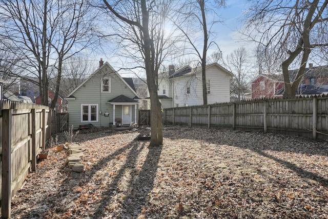 back of property featuring a fenced backyard