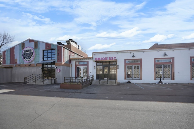 view of building exterior featuring uncovered parking