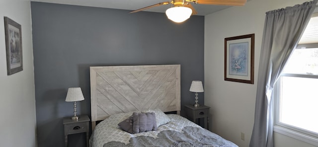 bedroom with ceiling fan and multiple windows