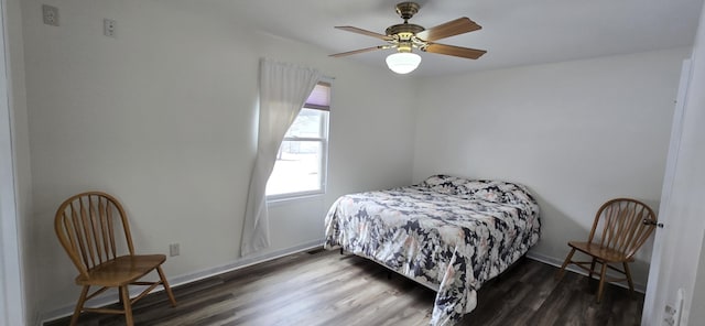 bedroom with ceiling fan, baseboards, and wood finished floors