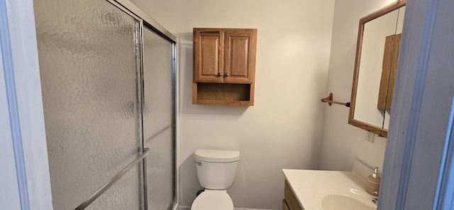 full bath featuring toilet, a stall shower, and vanity