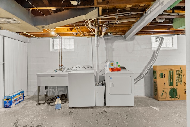 washroom featuring laundry area, a sink, and washing machine and clothes dryer