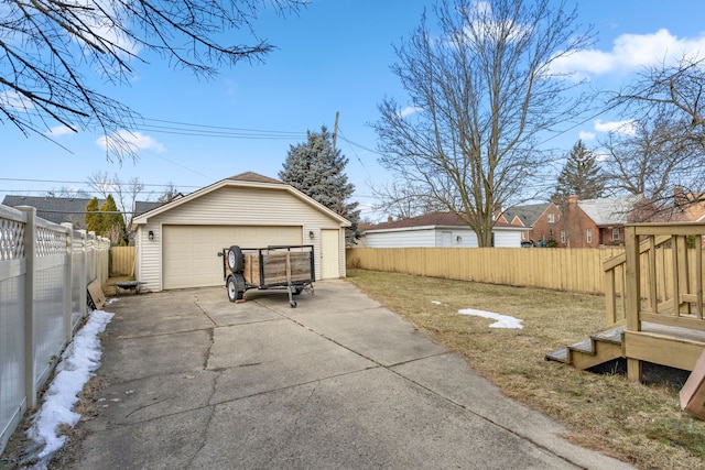 detached garage featuring fence