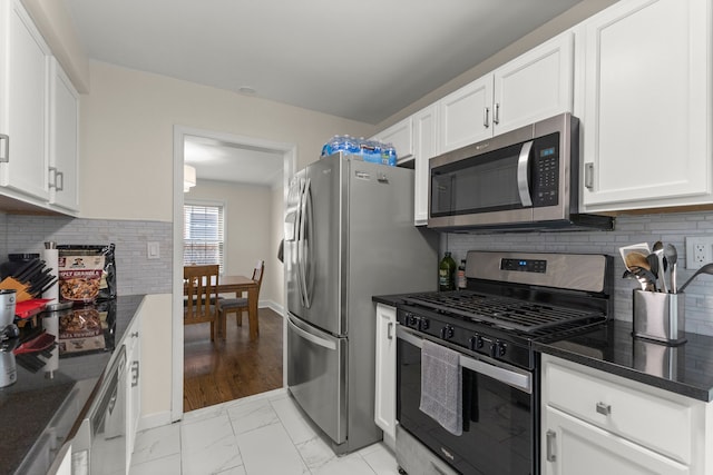 kitchen featuring white cabinets, marble finish floor, and stainless steel appliances