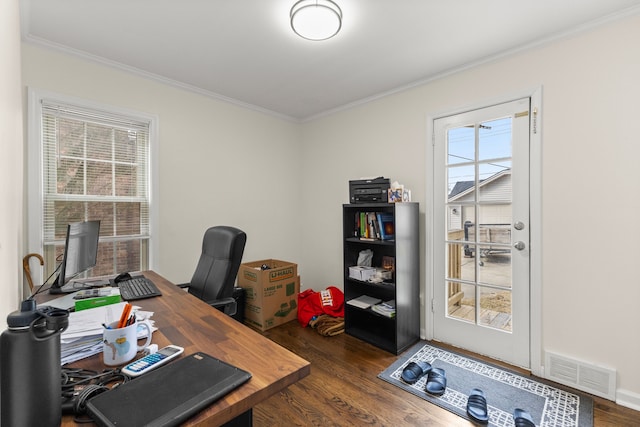 office area with dark wood-style flooring, plenty of natural light, visible vents, and crown molding