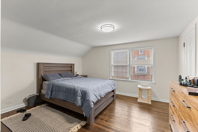 bedroom featuring lofted ceiling, dark wood-style flooring, and baseboards