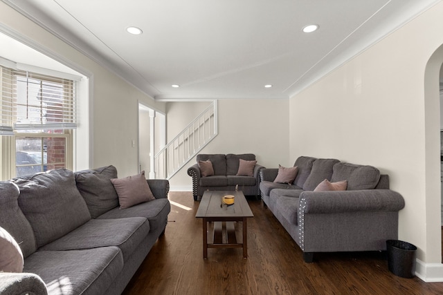 living area featuring arched walkways, stairs, dark wood finished floors, and recessed lighting