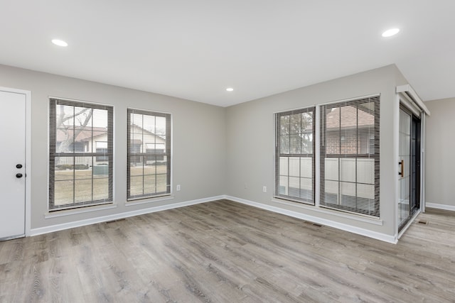 unfurnished room with visible vents, baseboards, wood finished floors, and recessed lighting