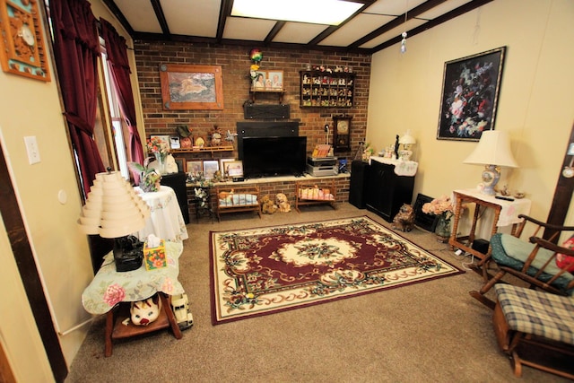 living room with beam ceiling, carpet flooring, and brick wall