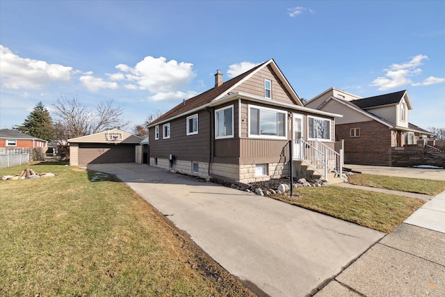 view of front of house with a garage, an outdoor structure, fence, a front lawn, and a chimney