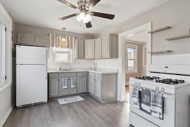 kitchen with white appliances, light wood finished floors, gray cabinetry, and open shelves