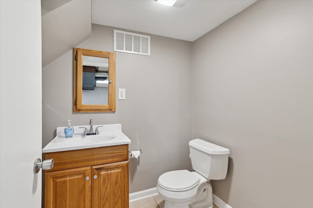 half bath featuring toilet, vanity, visible vents, and baseboards