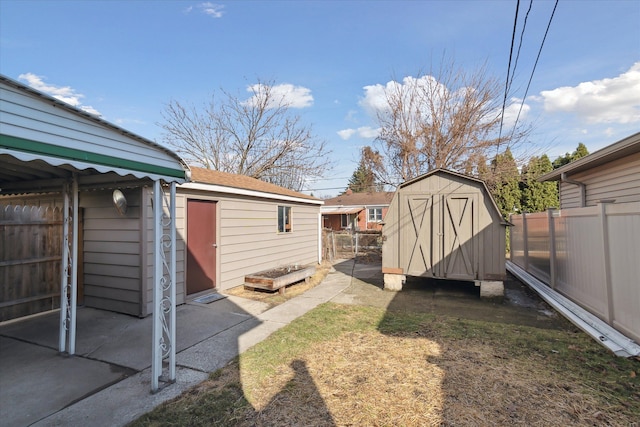 view of yard with a shed, fence, and an outdoor structure