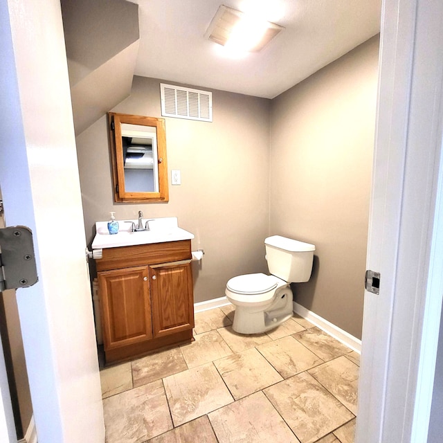 bathroom with baseboards, visible vents, vanity, and toilet