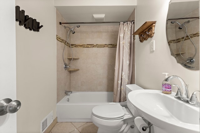 full bathroom with toilet, a sink, visible vents, tile patterned floors, and shower / bath combo with shower curtain