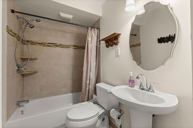 bathroom featuring shower / tub combo, a sink, and toilet