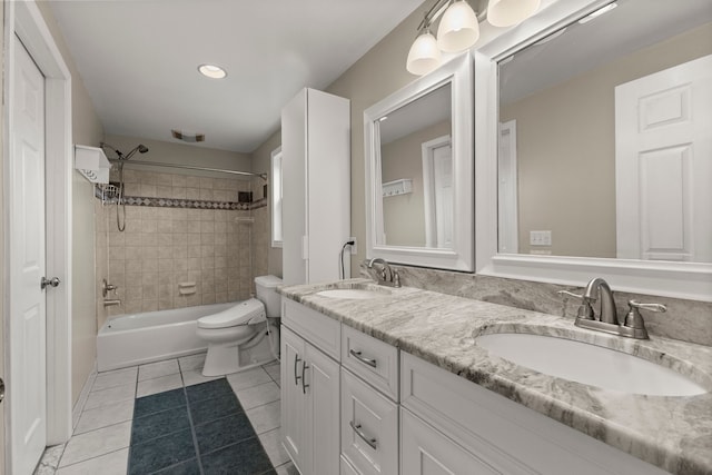 bathroom featuring toilet, tile patterned flooring, double vanity, and a sink