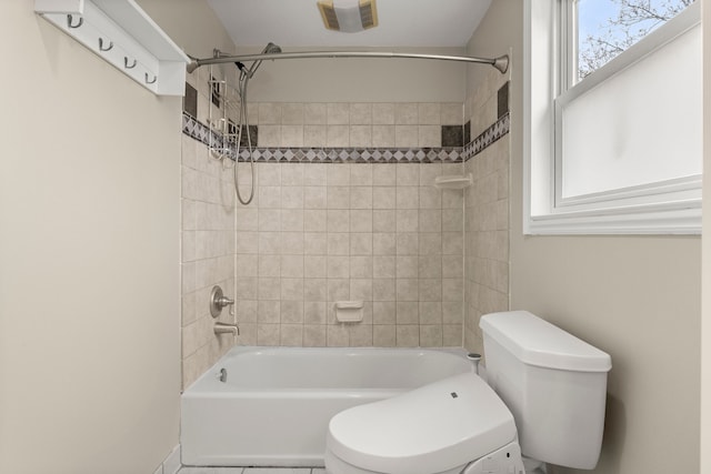 bathroom with visible vents, bathing tub / shower combination, and toilet