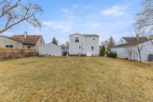 rear view of property with a yard and fence